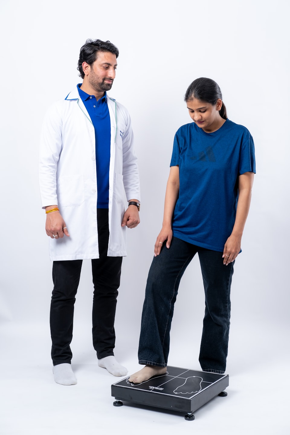 Clinician taking patients weight measurements. 